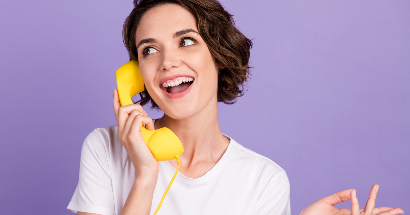 Customer service representative with a headset smiling and assisting clients.