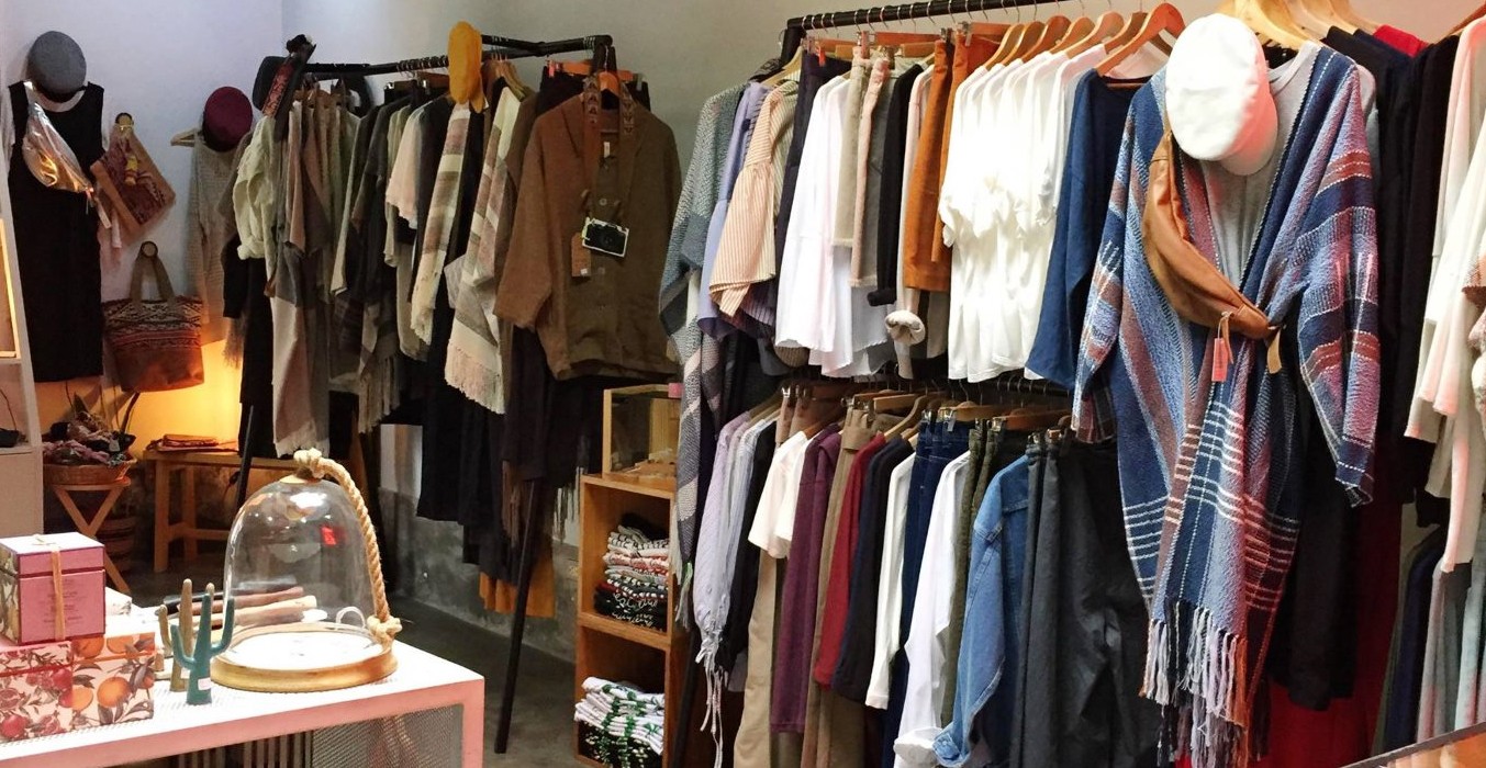 A variety of stylish clothing items neatly organized on hangers, showcasing a range of colors and designs.